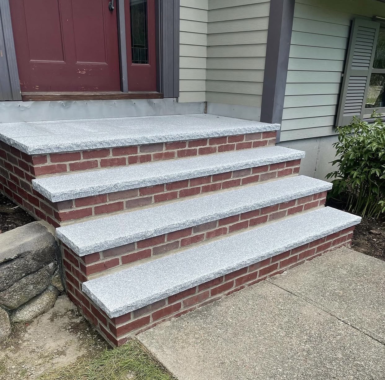 Completed brick stair rebuild with stone treads